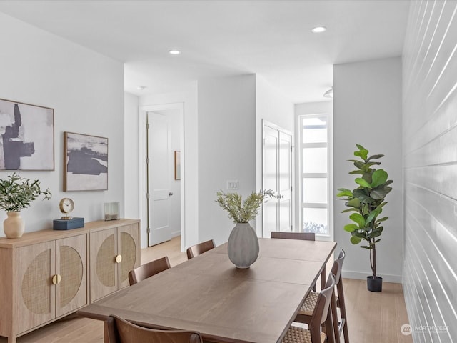 dining space with light hardwood / wood-style flooring