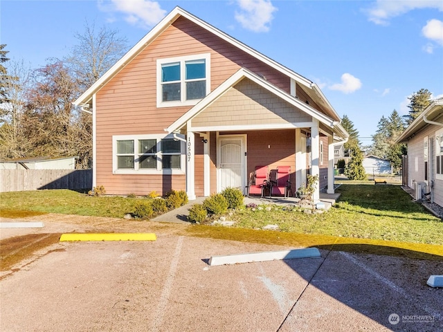 view of front of house with a porch and a front lawn