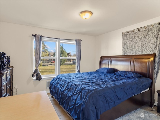 bedroom featuring light tile patterned flooring