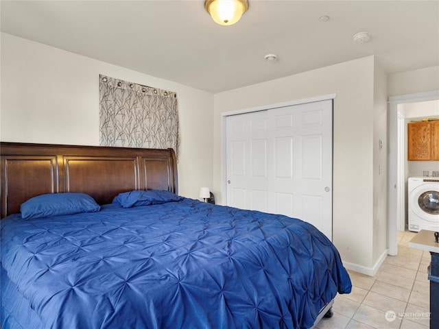 tiled bedroom featuring washer / dryer and a closet