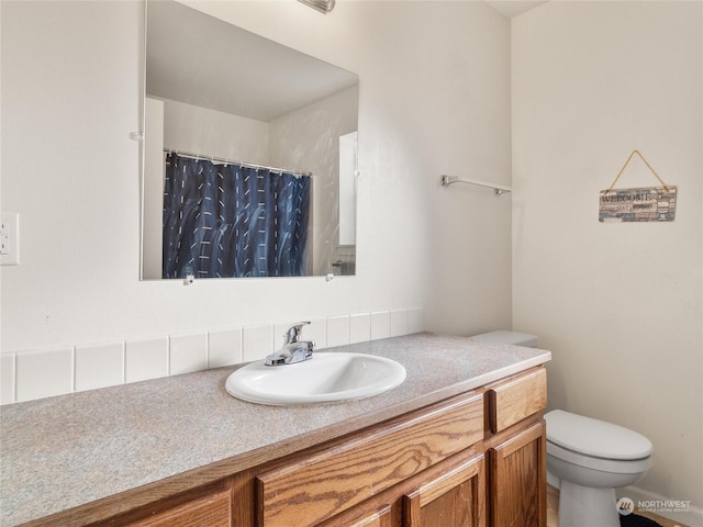 bathroom with vanity, toilet, and walk in shower