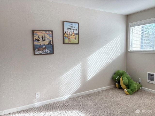 carpeted spare room with heating unit