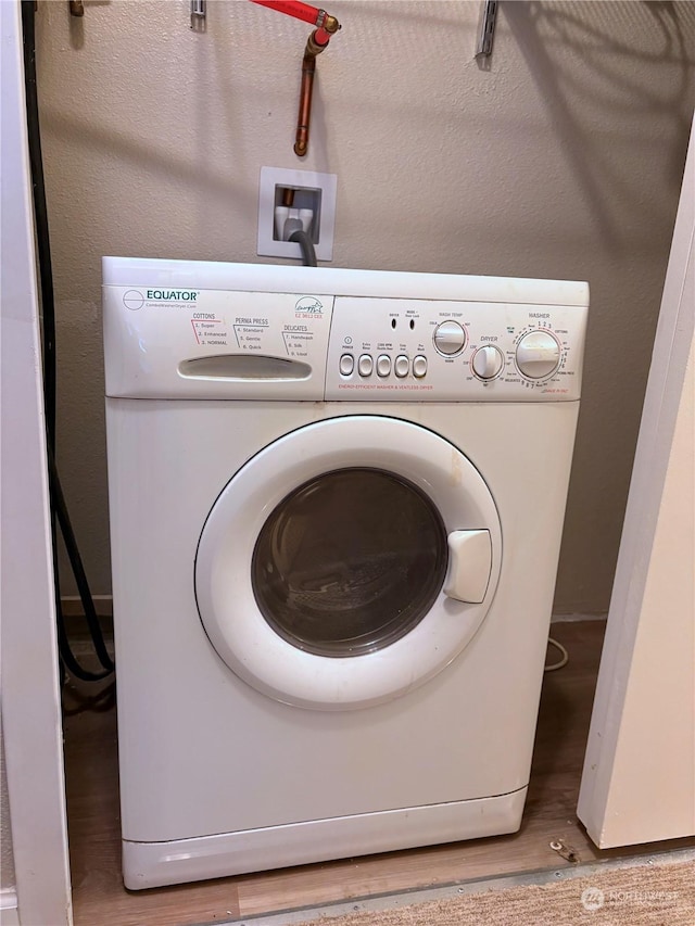 laundry area featuring wood-type flooring and washer / clothes dryer