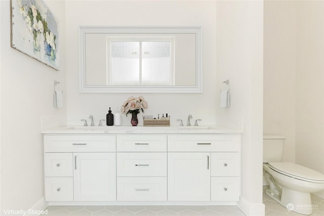 bathroom featuring vanity, tile patterned flooring, and toilet