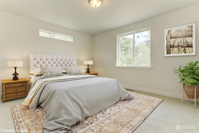 carpeted bedroom featuring multiple windows