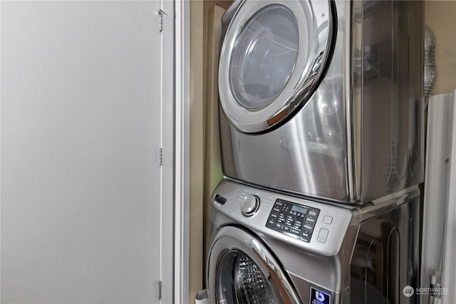 laundry room with stacked washer / dryer