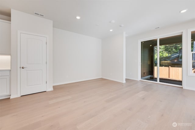 empty room with light hardwood / wood-style flooring