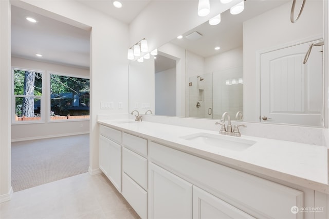 bathroom with an enclosed shower, vanity, and tile patterned floors