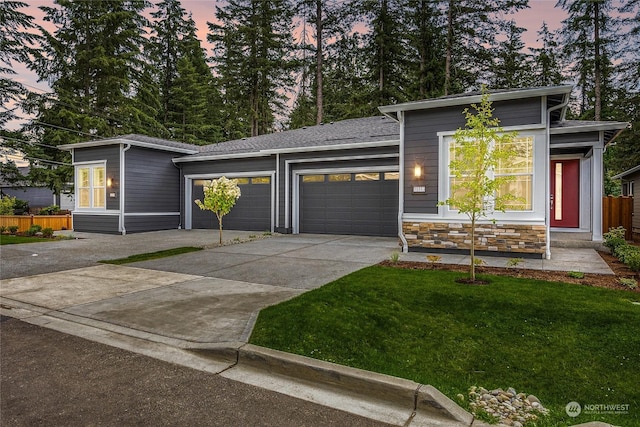 view of front of property featuring a yard and a garage