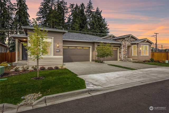 prairie-style house with a garage and a lawn