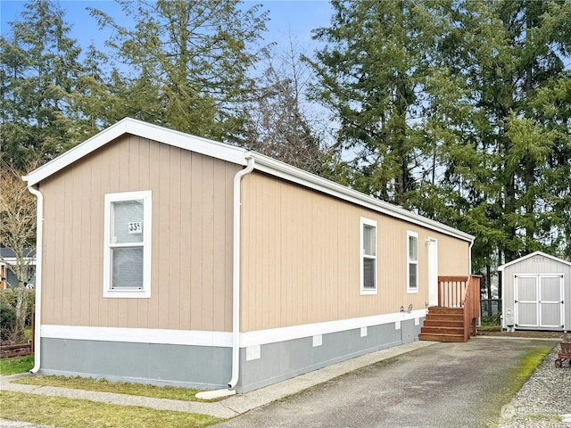 view of side of home with a shed