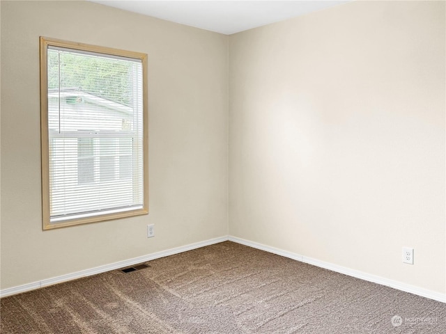 unfurnished room featuring carpet