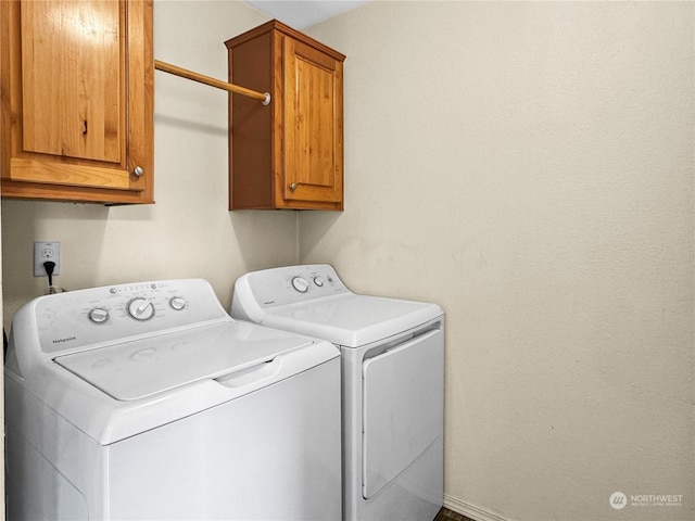 laundry area with cabinets and separate washer and dryer