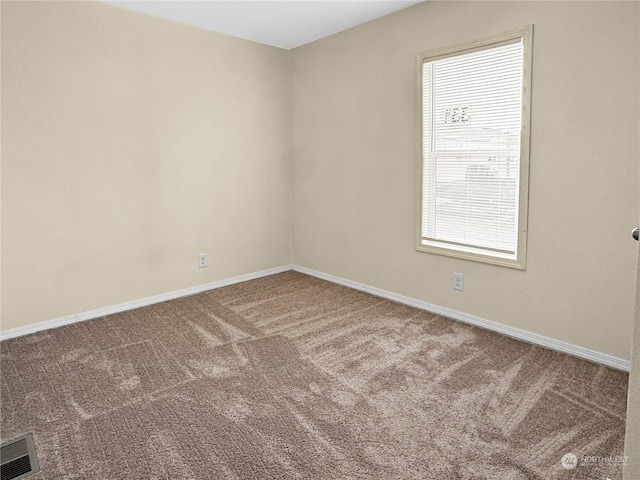 unfurnished room with a wealth of natural light and carpet floors