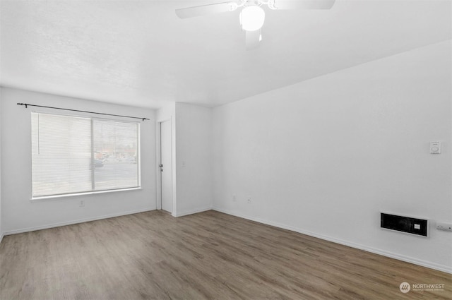 spare room featuring ceiling fan and hardwood / wood-style floors