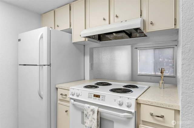 kitchen featuring white appliances and cream cabinetry