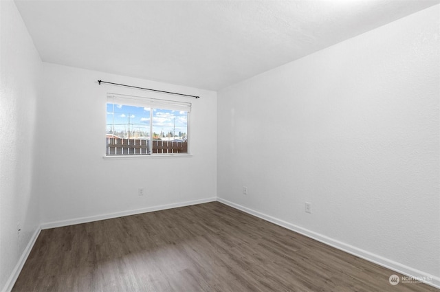 empty room with dark hardwood / wood-style floors