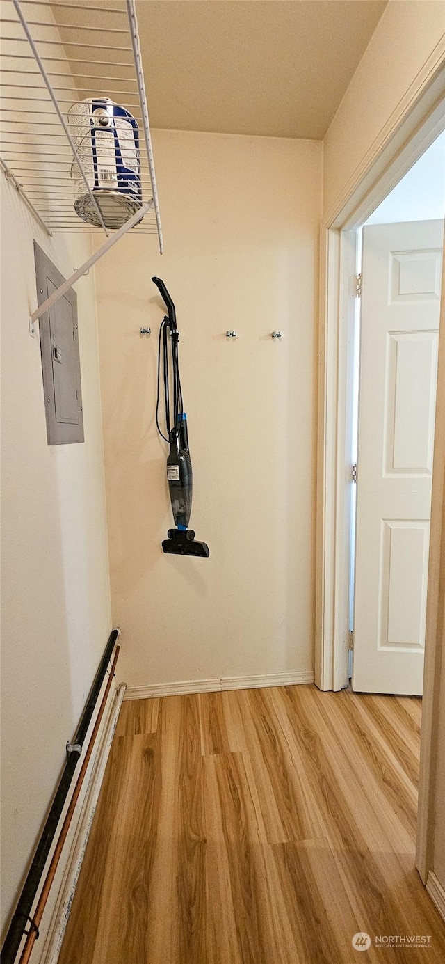 hallway featuring hardwood / wood-style flooring and electric panel