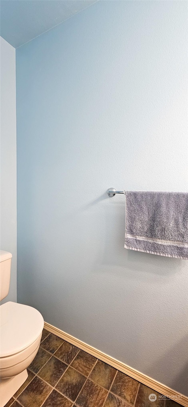 bathroom with tile patterned flooring and toilet