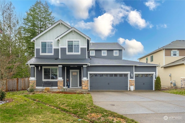 craftsman-style house featuring a garage, covered porch, and a front lawn