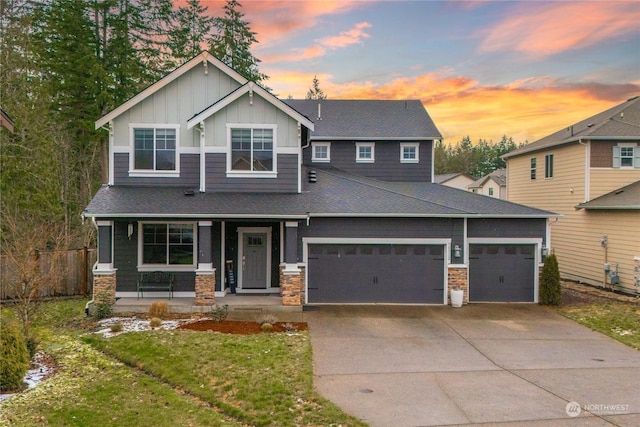 craftsman house featuring a garage, a yard, and covered porch