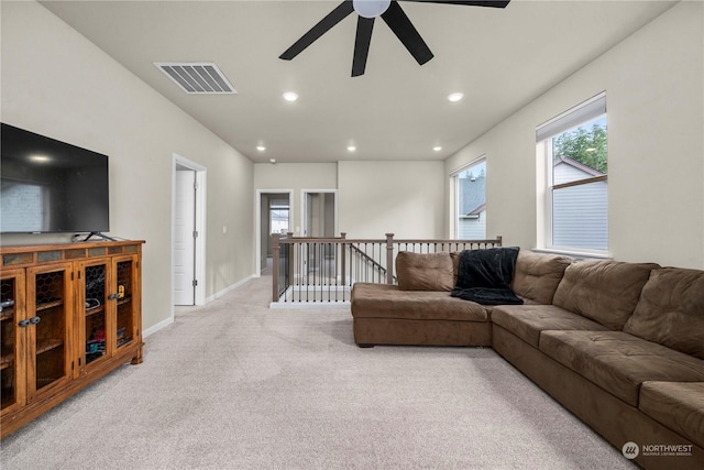 carpeted living room featuring ceiling fan