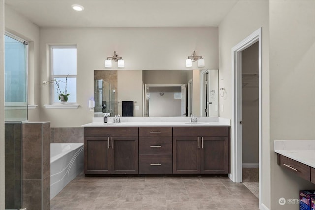 bathroom featuring vanity, tile patterned floors, and separate shower and tub