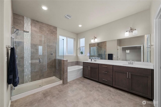 bathroom featuring vanity and shower with separate bathtub