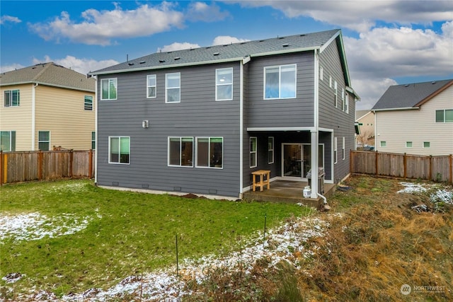 snow covered property with a patio and a lawn