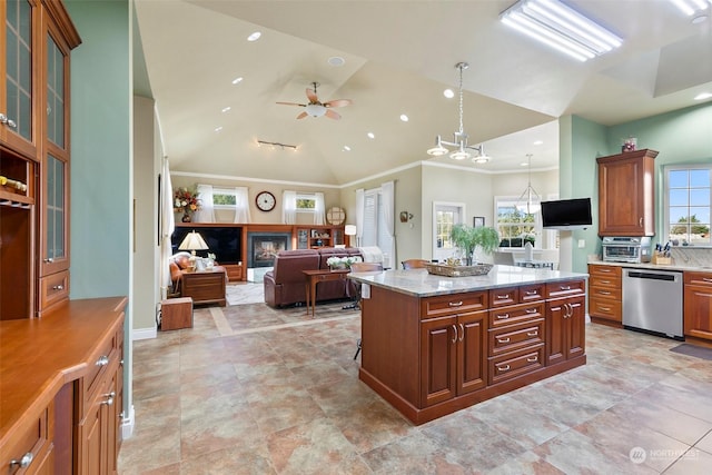 kitchen featuring dishwasher, a kitchen island, a healthy amount of sunlight, and light stone counters