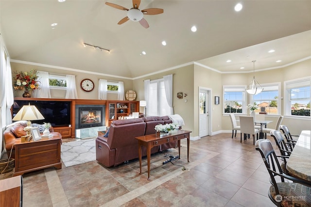 living room with crown molding, track lighting, ceiling fan, and vaulted ceiling