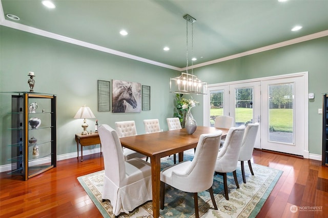 dining area with hardwood / wood-style flooring and crown molding