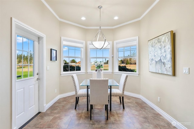 dining room with crown molding and a healthy amount of sunlight