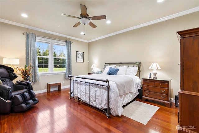 bedroom with crown molding, dark wood-type flooring, and ceiling fan