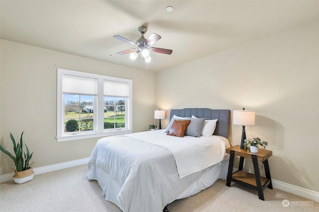 bedroom with ceiling fan and light carpet