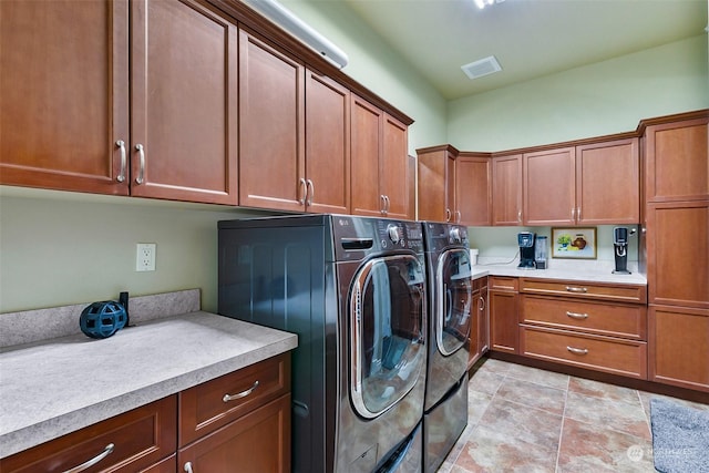 laundry room featuring separate washer and dryer, cabinets, and light tile patterned flooring