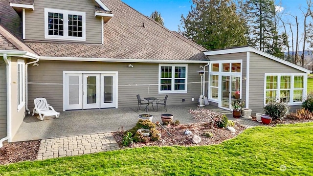 back of property featuring a yard and a patio area