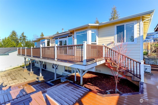 back of house with a patio area and a deck