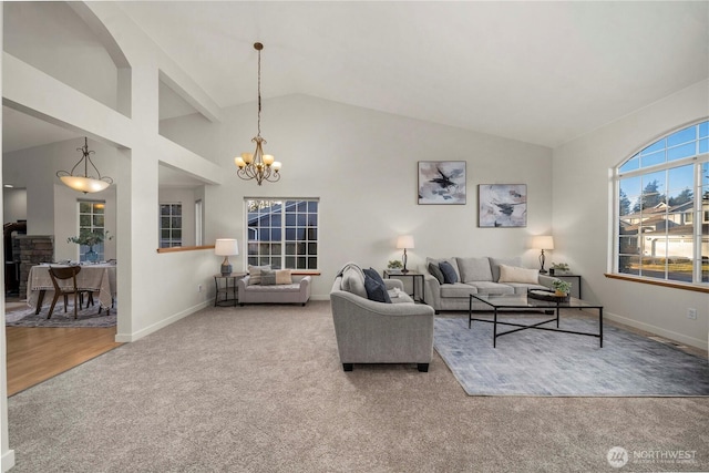 carpeted living room with high vaulted ceiling and a notable chandelier