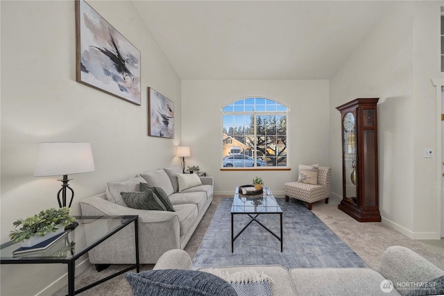 carpeted living room featuring lofted ceiling