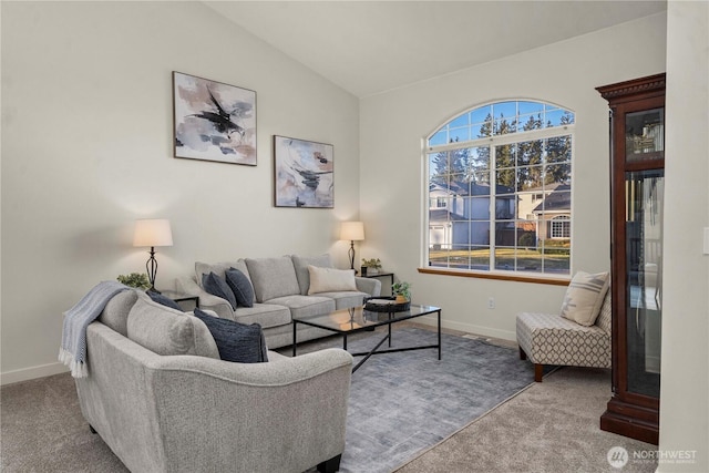 carpeted living room with vaulted ceiling