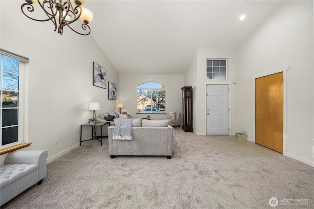 living room with an inviting chandelier, light carpet, and high vaulted ceiling