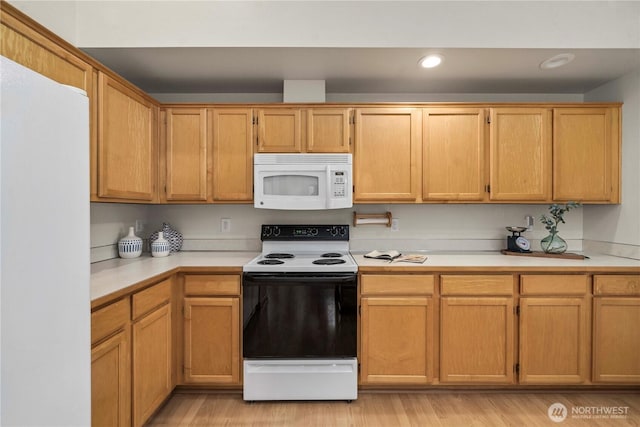 kitchen featuring electric stove and light hardwood / wood-style floors