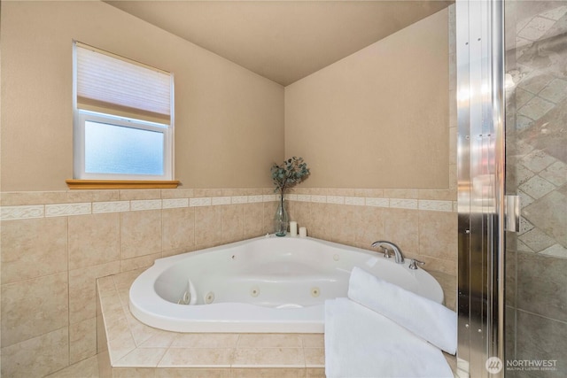 bathroom featuring a relaxing tiled tub