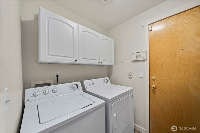 laundry room with cabinets and washing machine and dryer