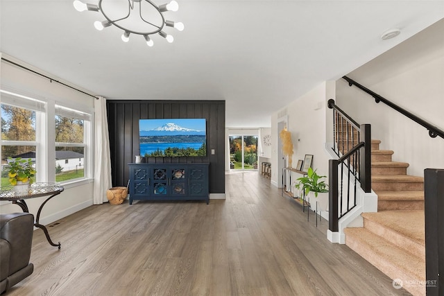 living room with hardwood / wood-style flooring and a notable chandelier