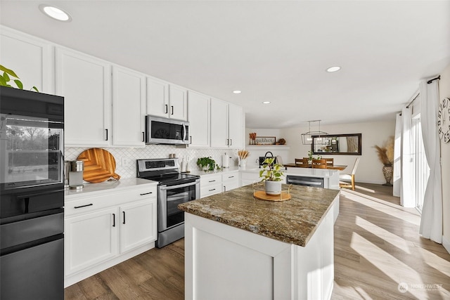 kitchen featuring a kitchen island, appliances with stainless steel finishes, and white cabinets