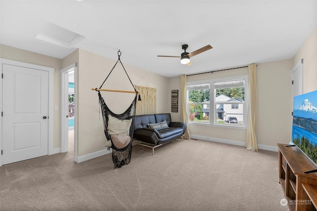 living area with light colored carpet and ceiling fan