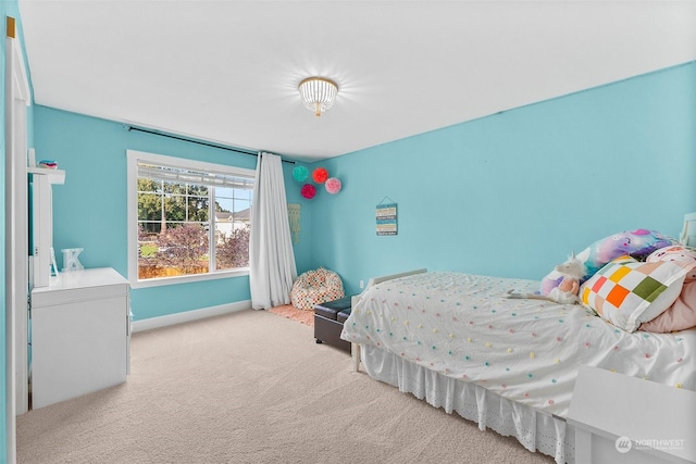 bedroom featuring light carpet