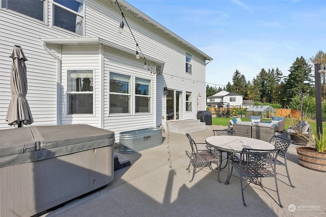 view of patio with a hot tub, an outdoor hangout area, and grilling area